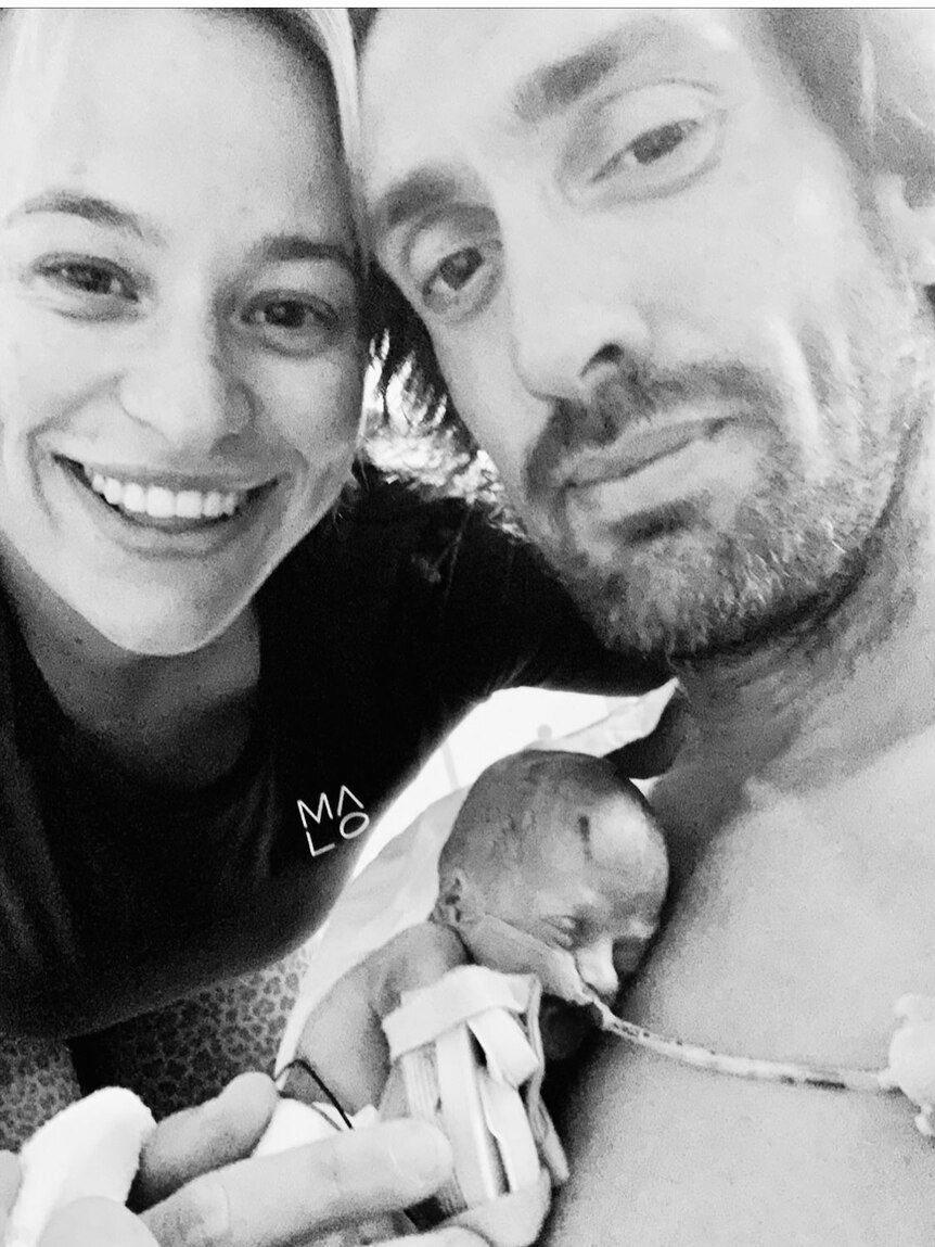 Mother and father with premature baby on life support