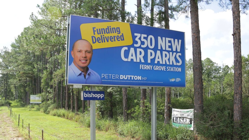 A Peter Dutton billboard in his electorate of Dickson promising 350 new car parks for Ferny Grove Station.