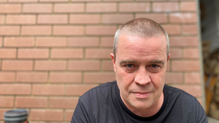 A portrait of a man with close cropped hair.