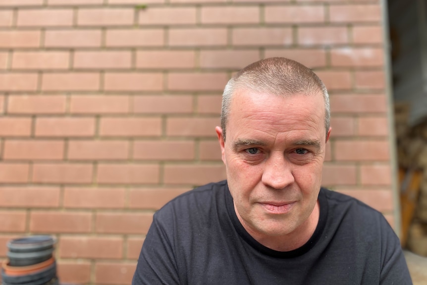 A portrait of a man with close cropped hair.