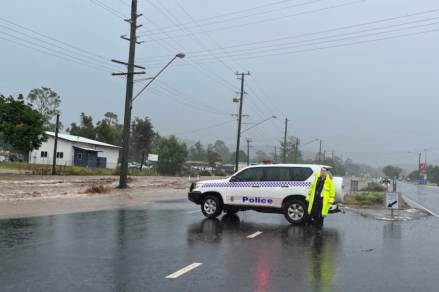 Police close highway at Withcott at bottom of Toowoomba range after heavy rain