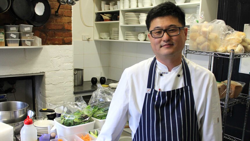 Chef Taewoo Kim standing in the kitchen at the Richmond cafe he works in, 12 August 2014.