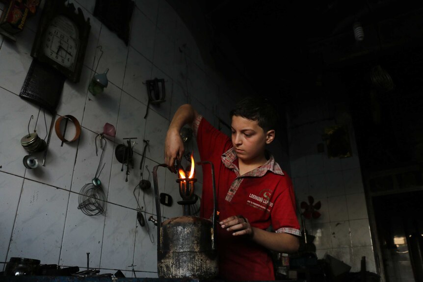 Syrian child labours in factory