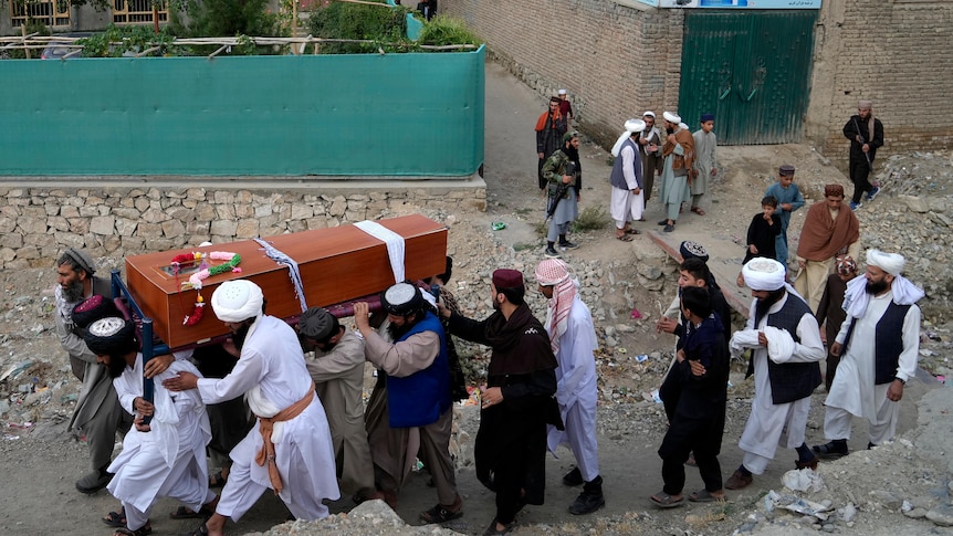 Mourners carry a coffin
