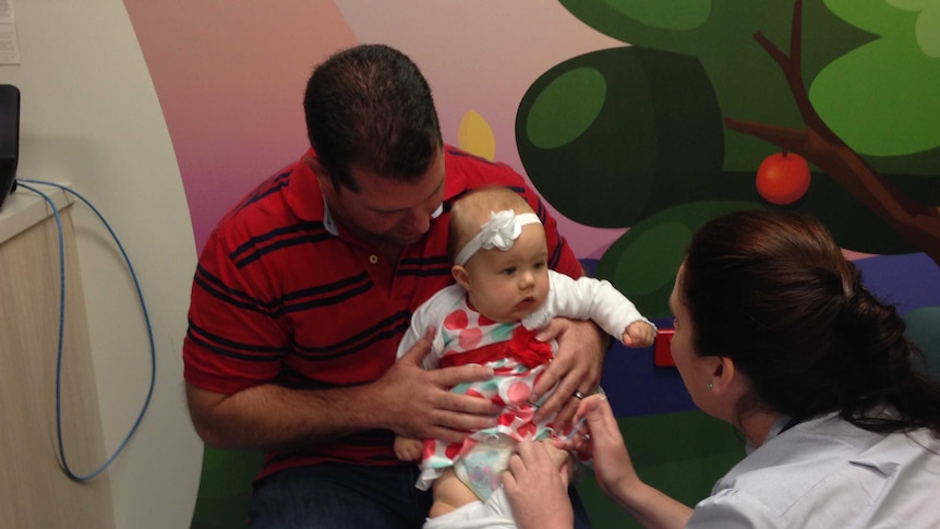 Nurse Leanne Philips gives baby Iriana Cosford her vaccination at the new Queensland Specialist Immunisation Service