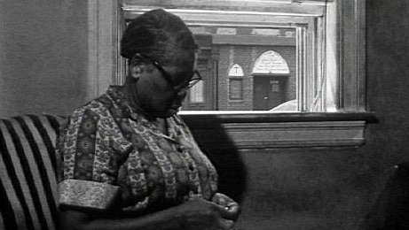 Elderly African-American woman sits in house