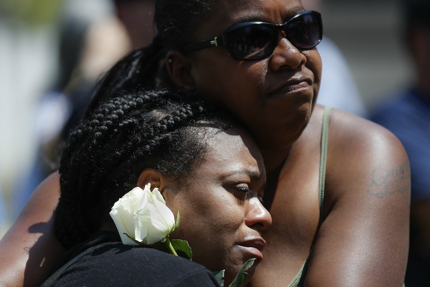 Mourners gather at a vigil following a nearby mass shooting in Dayton, Ohio.