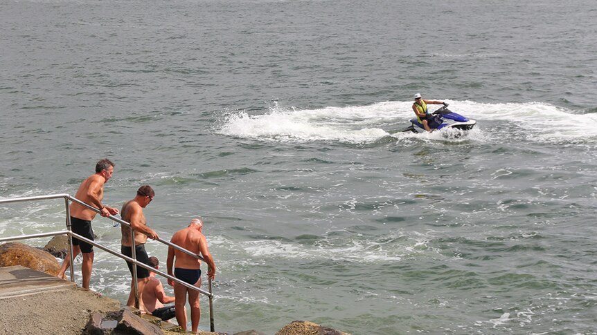 A jet ski near swimmers on the Gold Coast Broadwater