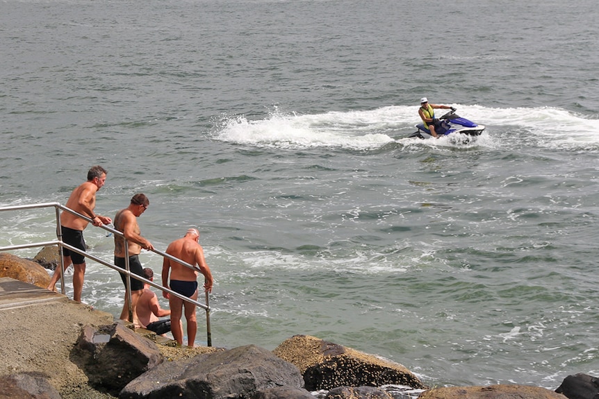 A jet ski near swimmers on the Gold Coast Broadwater