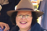 A woman in an Akubra hat smiling