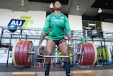 Australian women's rugby player Ellia Green takes the strain as she lifts a large weight in the gym. 