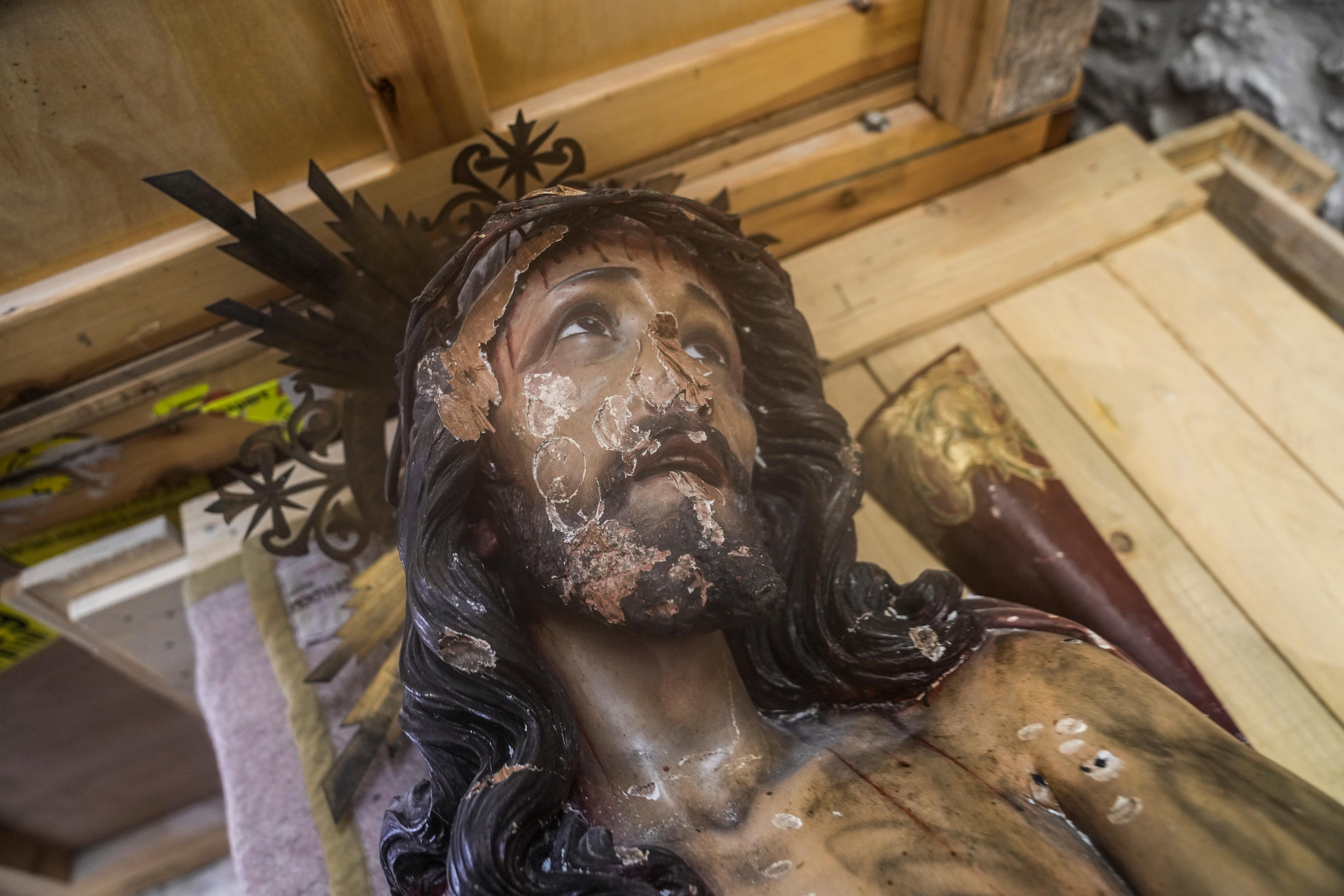 A statue of Jesus has damage to the face in a churhch in Jerusalem.