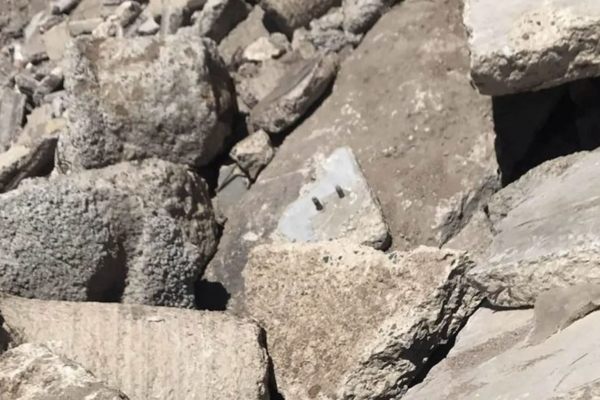Broken-off chunks of grey concrete in a pile