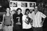 Four Timor-Leste activists stand in front of photo display