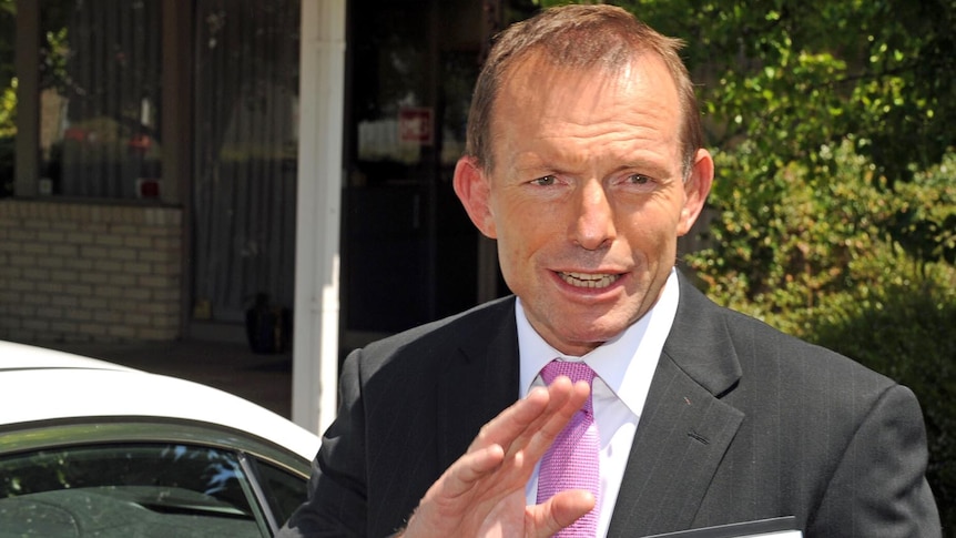 Opposition Leader Tony Abbott waves as he gets into a car in Canberra on November 1, 2011.