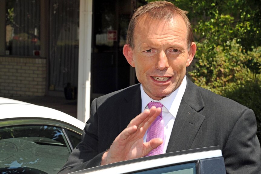 Opposition Leader Tony Abbott waves as he gets into a car in Canberra on November 1, 2011.