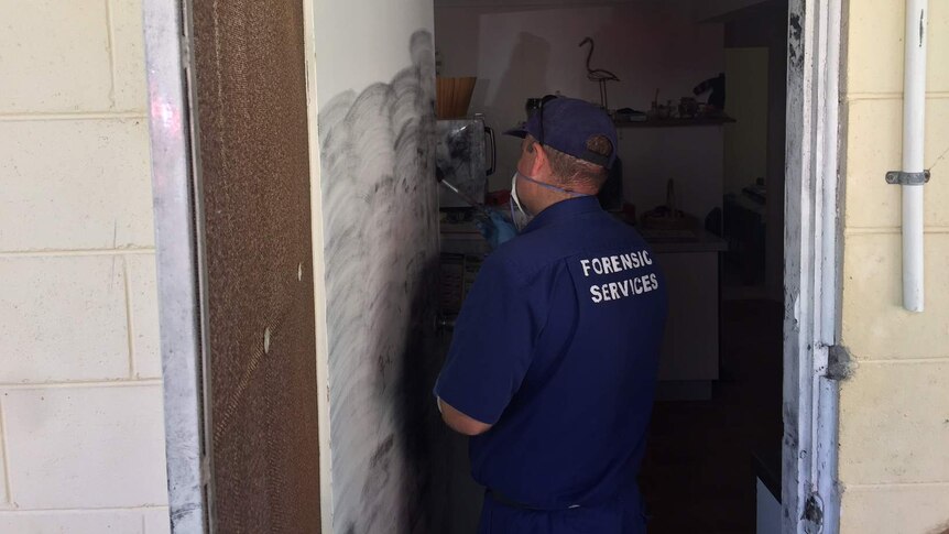 Police dusting the scene of a home invasion in Sawtell for fingerprints.
