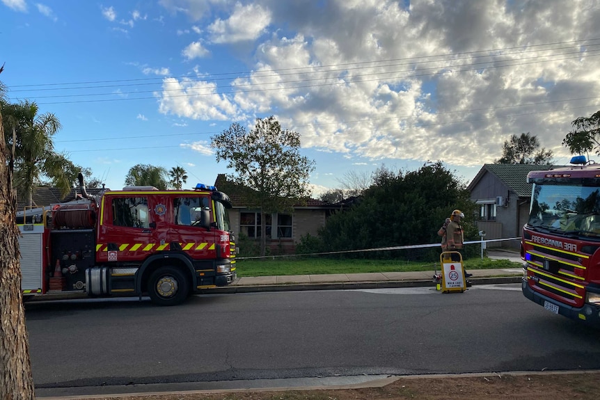 MFS crews and trucks on the street outside the home on Tarana Avenue, Ingle Farm