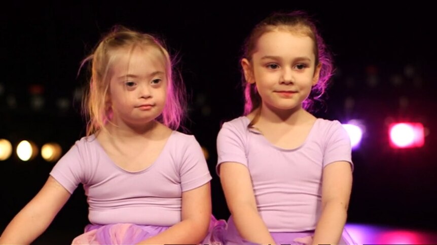 Two girls wearing ballet outfits