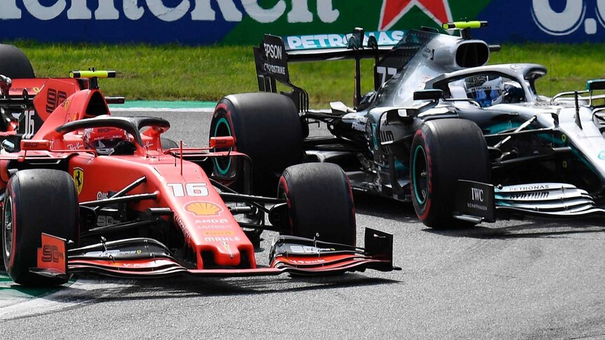 Lewis Hamilton and Charles Leclerc drive next to each other in their silver Mercedes and red Ferrari respectively