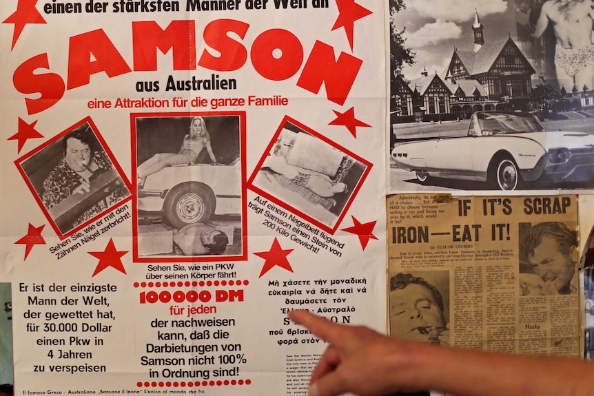 Leon Samson points to an old poster for his show in Germany.