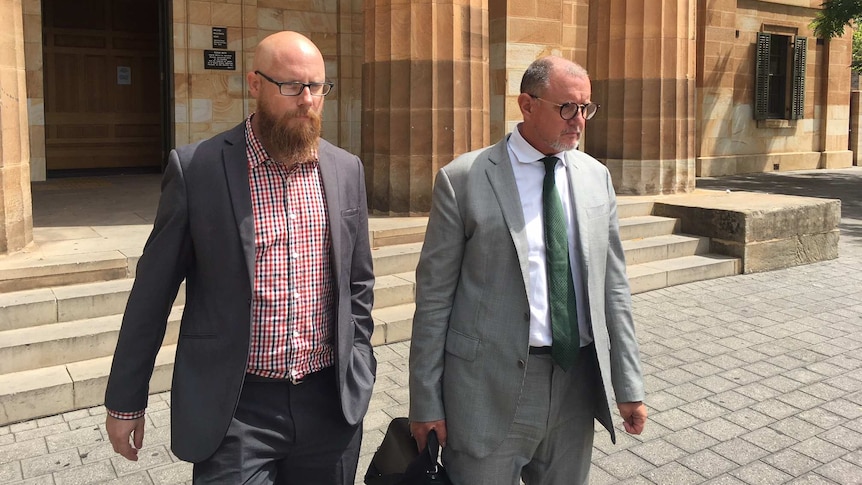 Two men in suits outside a court