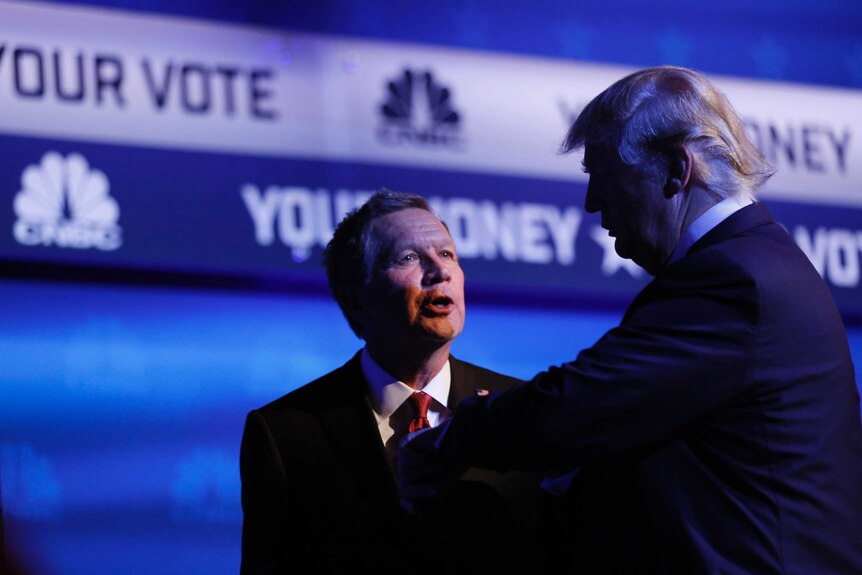 Donald Trump and John Kasich talking on a debate stage