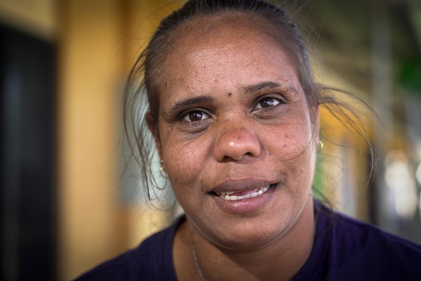 a close-up image of an aboriginal woman wearing a ponytail
