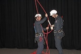 TFS trainee Tim Peterson (r) gets ready to abseil July 22, 2016