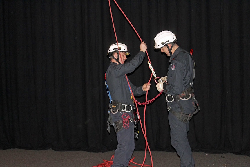 TFS trainee Tim Peterson (r) gets ready to abseil July 22, 2016