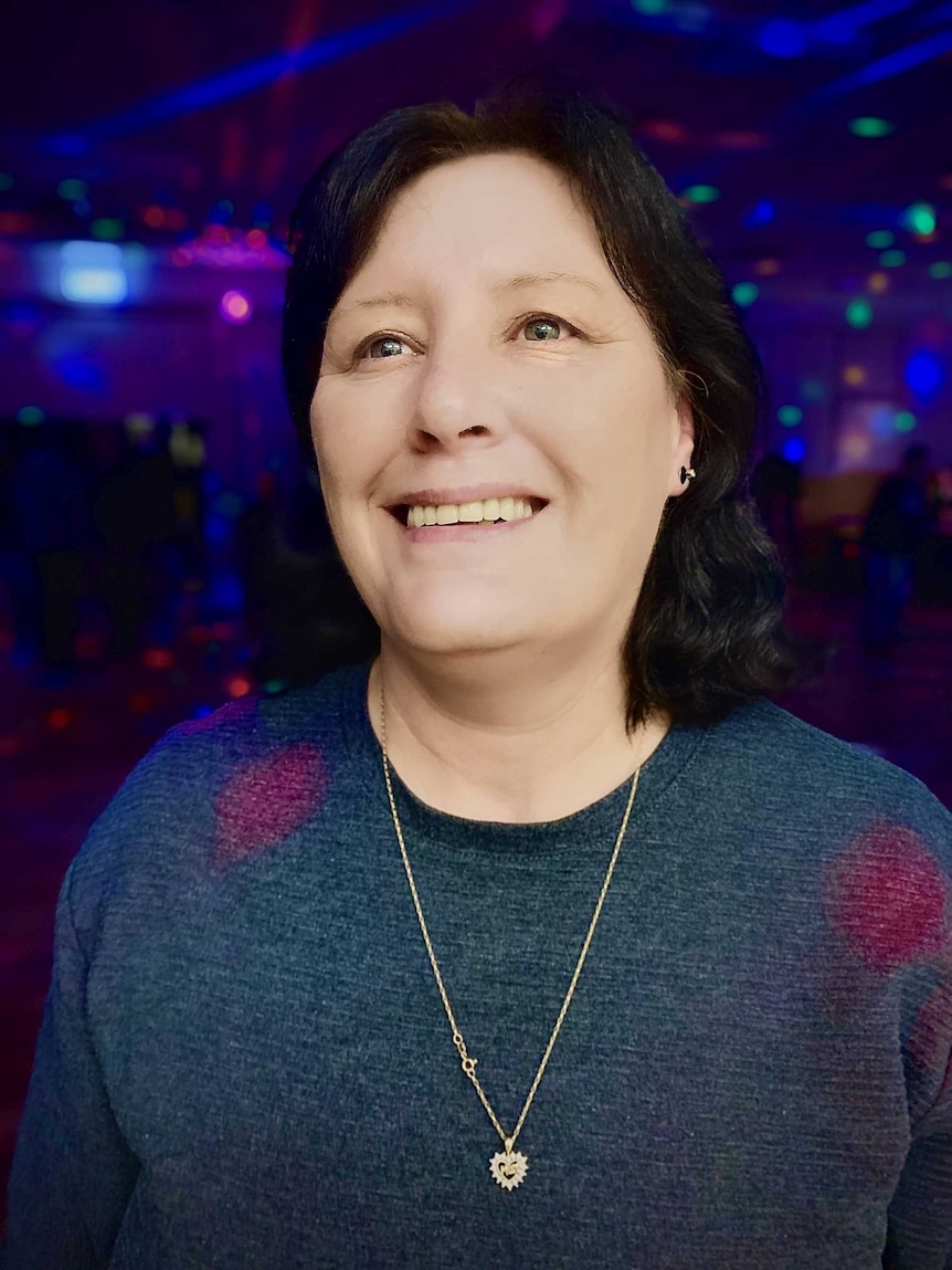 Karen smiles while at the disco.
