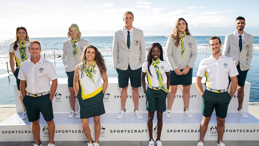 A group of Australian athletes stand wearing the uniform designed for wear at the Olympics opening ceremony in Tokyo.