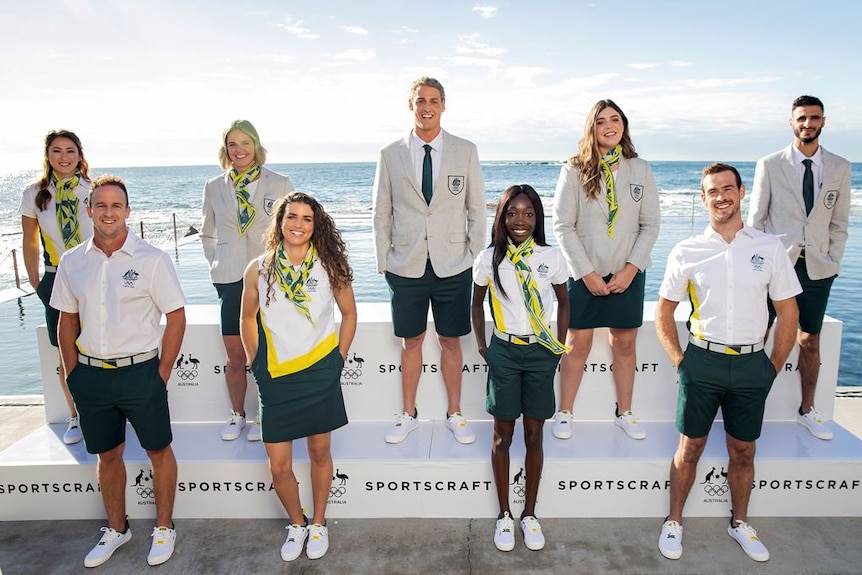 A group of Australian athletes stand wearing the uniform designed for wear at the Olympics opening ceremony in Tokyo.