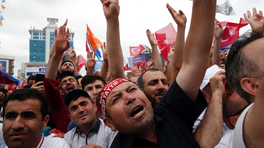 Supporters of Turkey's President Recep Tayyip Erdogan attend an election rally