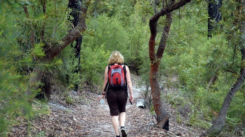 A woman enjoys a day of bushwalking