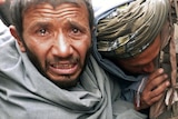 A mourner cries over the bodies of Afghan civilians, allegedly shot by a rogue US soldier