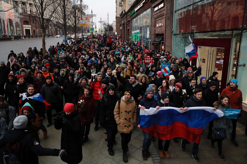 Hundreds of protesters walk in a rally in Moscow.
