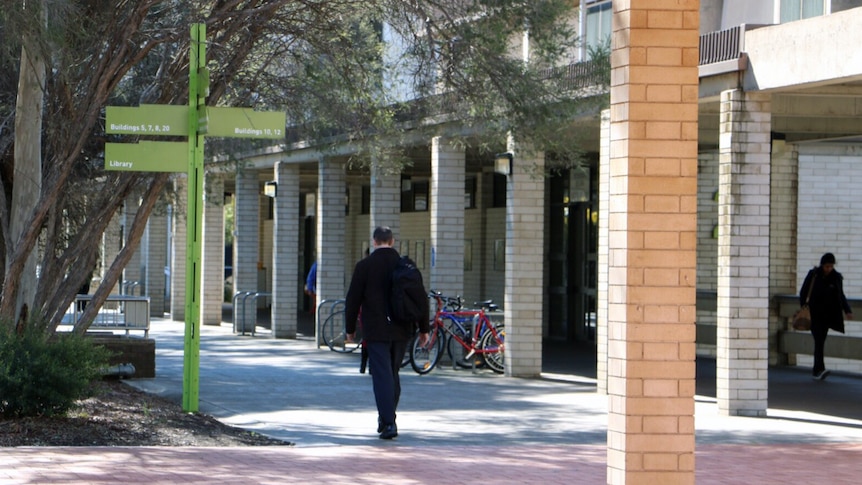 Student walking to class at University of Canberra campus.