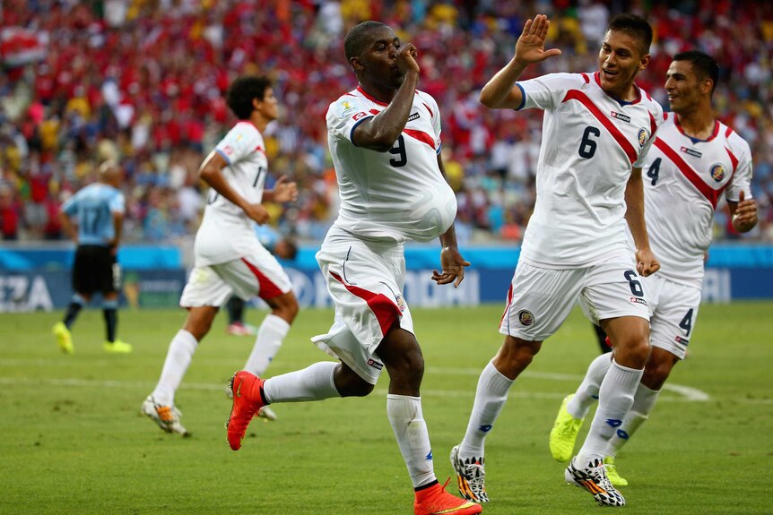 Costa Rica forward Joel Campbell (L) celebrates against Uruguay.