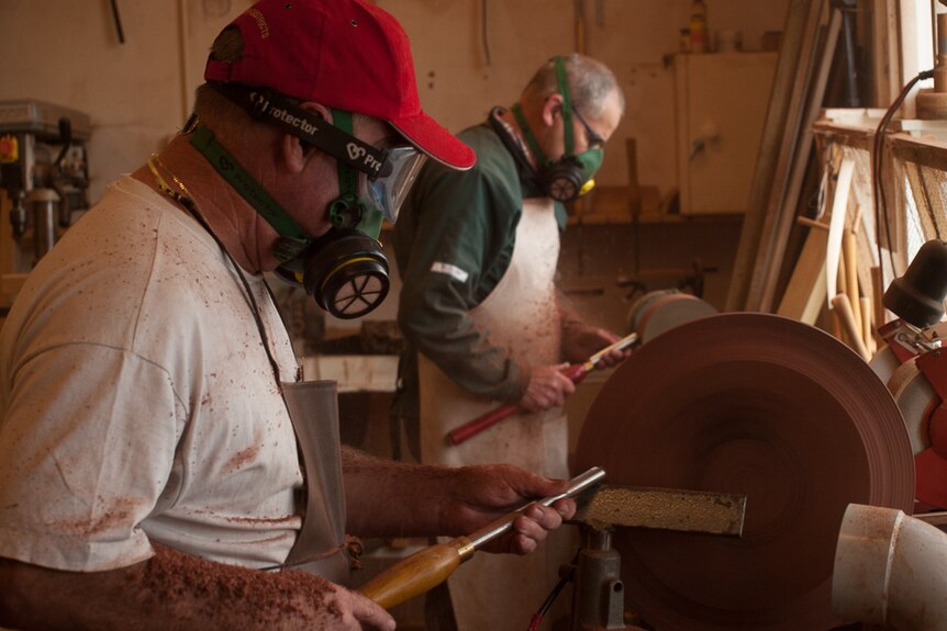 Bob Radley and Tom Davey work on the lathes.