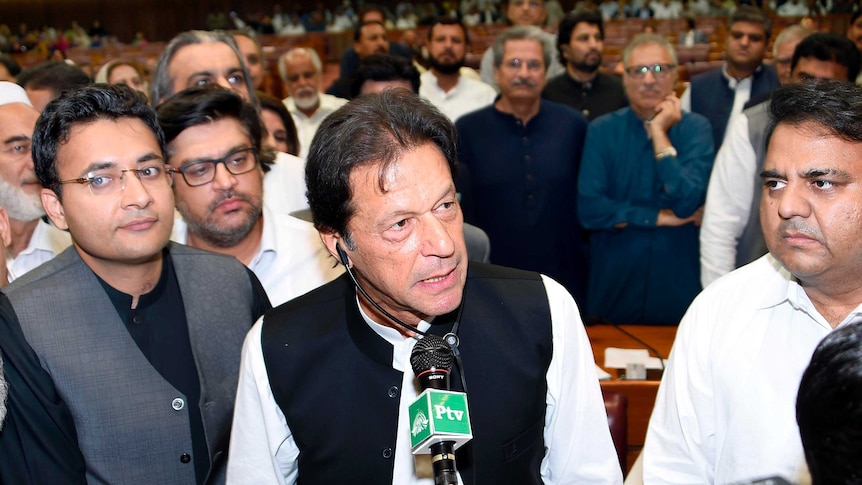 Imran Khan speaks into a microphone