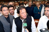 Imran Khan speaks into a microphone