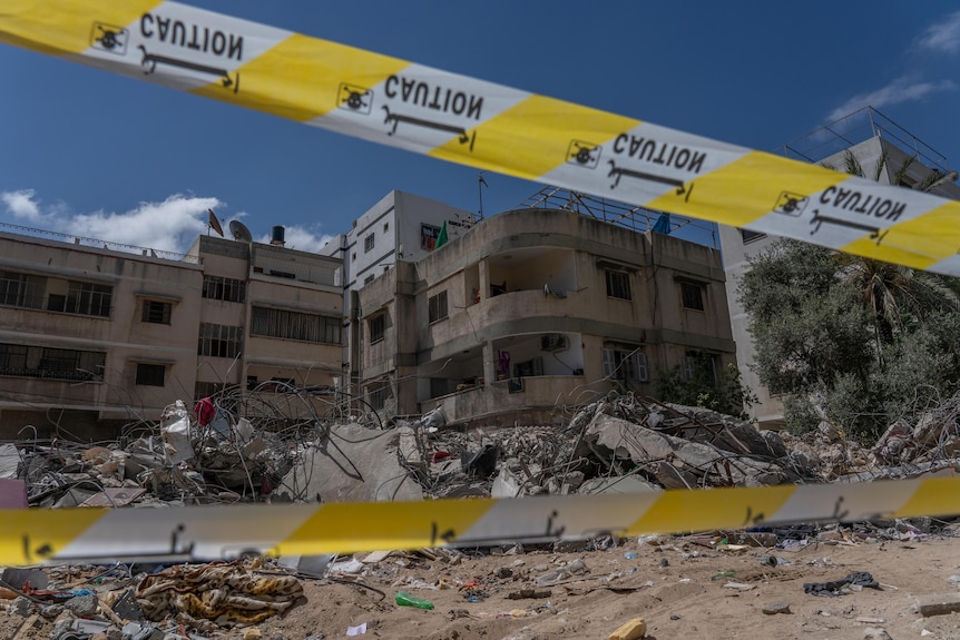 A blown apart building roped off with police tape in Gaza 