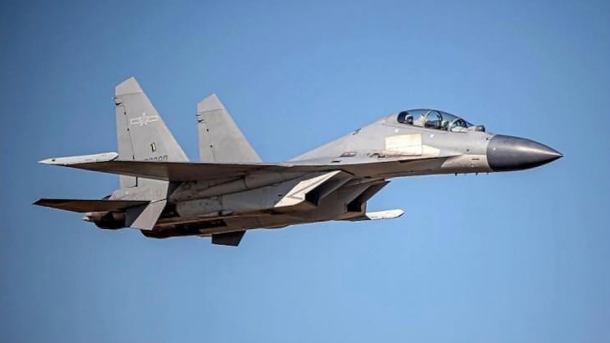 A fighter jet against a blue sky.