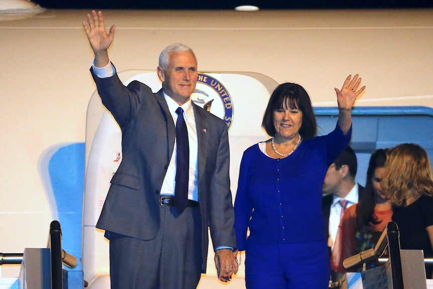 US Vice-President Mike Pence and his wife karen wave from the plane as they disembark in Sydney