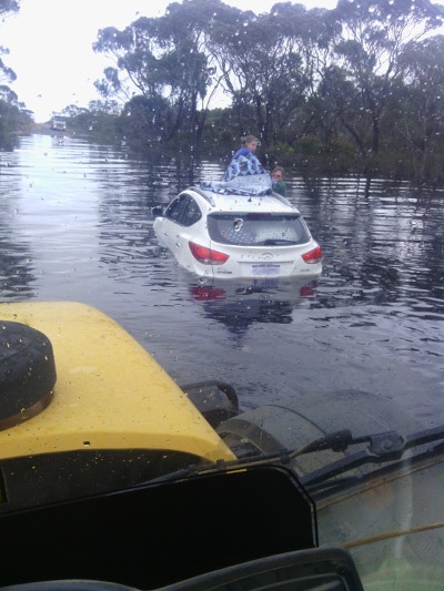 car stuck flooded highway