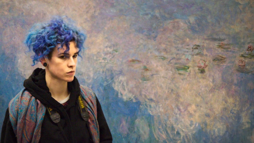 Woman stands in front of Monet's Nymphea