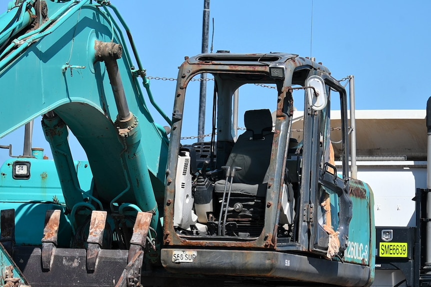 An excavator cab with no windows, front or doors