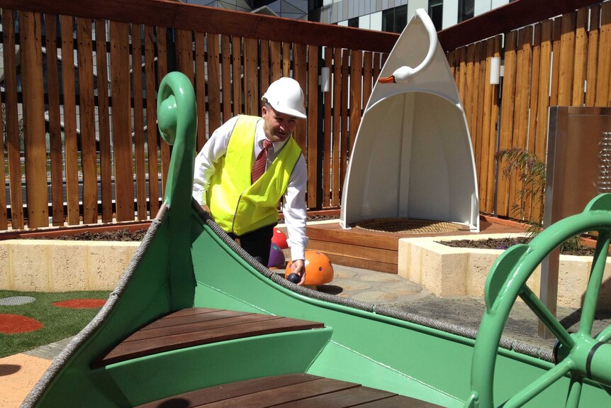 Kim Hames checks out the boat in the hospital's playground