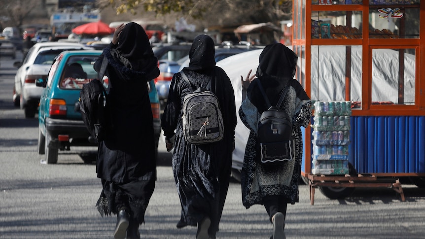 Afghan female students walk near Kabul University.